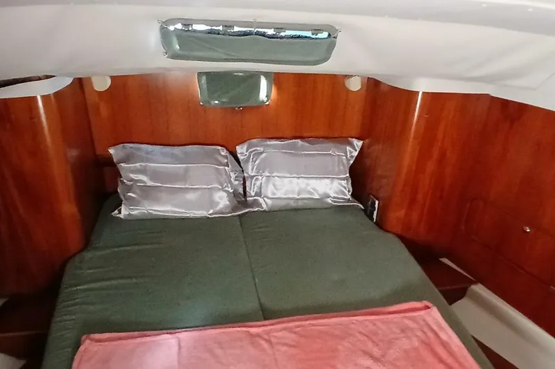 Slide: The Image of Cozy cabin interior of 1994 Beneteau Oceanis 44 CC with wood paneling and comfortable bedding. - 42
