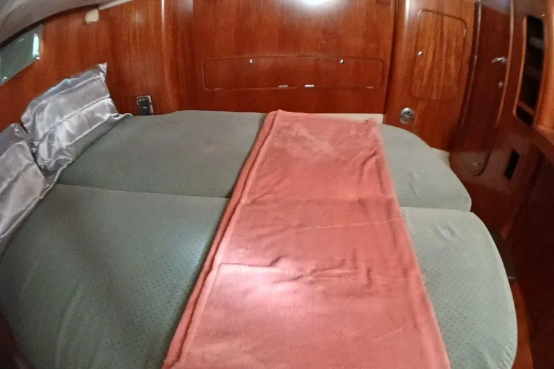 Slide: The Image of Cozy cabin interior of 1994 Beneteau Oceanis 44 CC with double bed and wooden finish. - 43