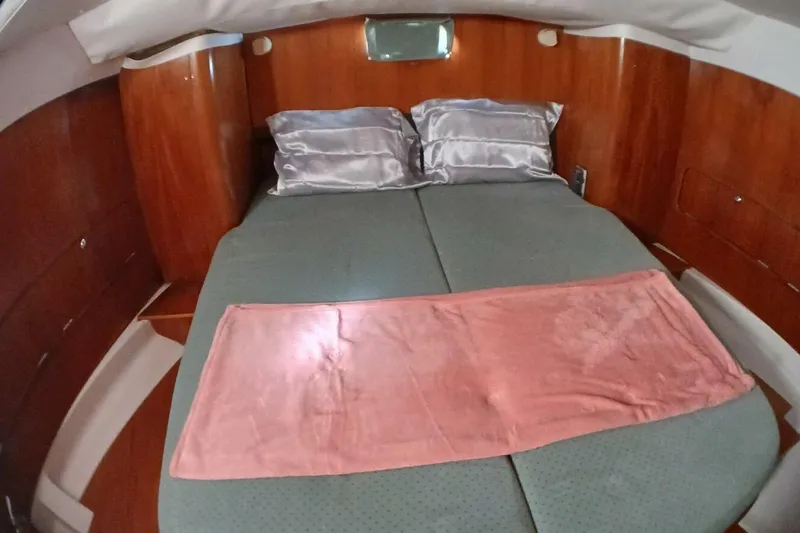 Slide: The Image of Cozy cabin interior of 1994 Beneteau Oceanis 44 CC with double bed and wooden finish. - 44
