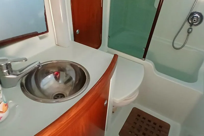 Slide: The Image of Bathroom interior of 1994 Beneteau Oceanis 44 CC yacht, featuring sink and shower. - 46