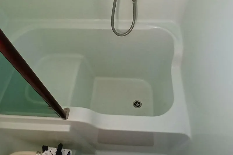 Slide: The Image of Shower area in 1994 Beneteau Oceanis 44 CC yacht, featuring a clean, white design. - 48