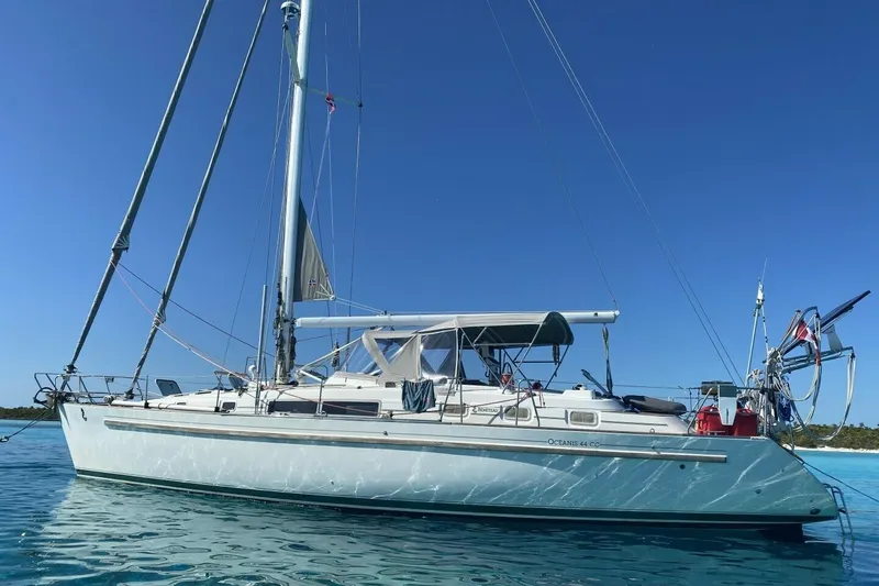 Slide: The Image of 1994 Beneteau Oceanis 44 CC sailboat on calm blue water under clear sky. - 5