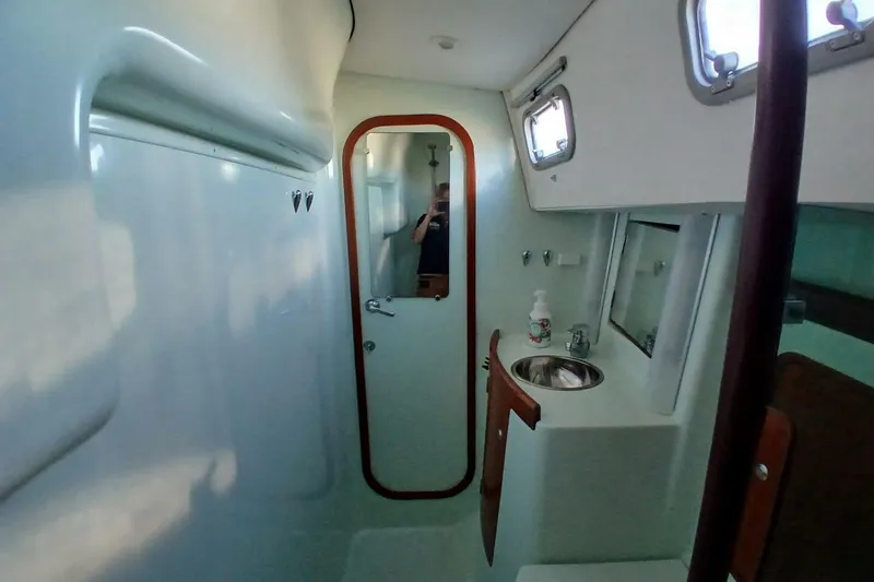 Slide: The Image of Interior of 1994 Beneteau Oceanis 44 CC yacht bathroom with sink and mirror. - 52