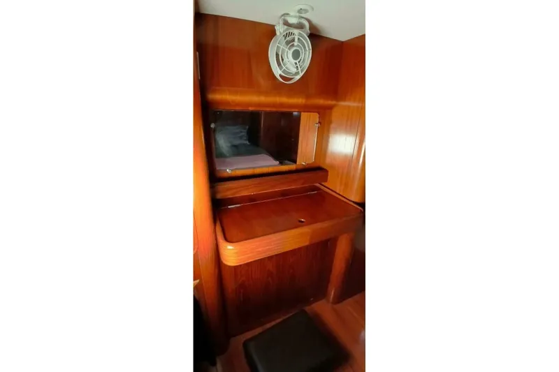 Slide: The Image of Interior of 1994 Beneteau Oceanis 44 CC yacht with wooden desk and mirror. - 53