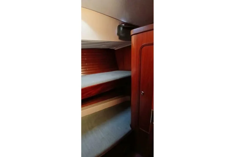 Slide: The Image of Interior cabin of 1994 Beneteau Oceanis 44 CC with wooden bunk beds. - 56
