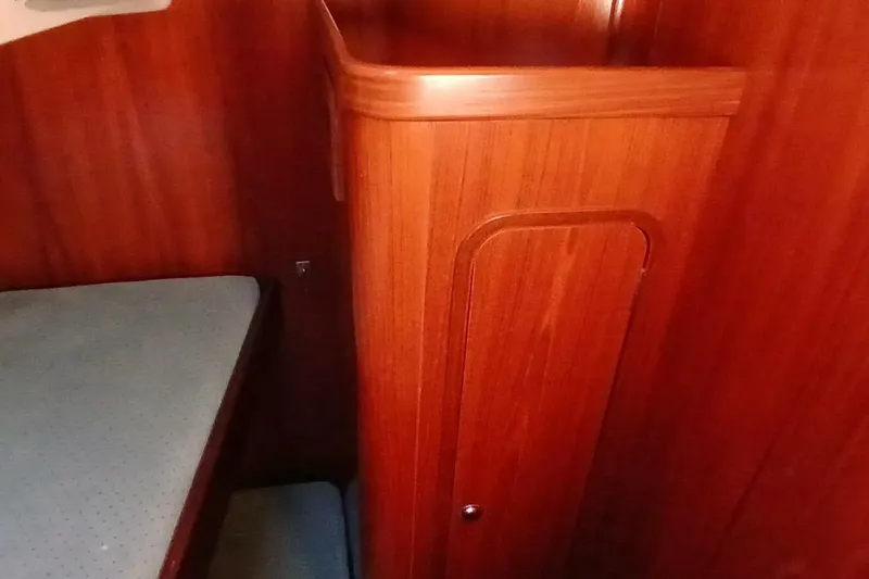 Slide: The Image of Interior of 1994 Beneteau Oceanis 44 CC sailboat with wooden cabinetry and berth. - 60