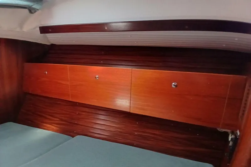 Slide: The Image of Interior of 1994 Beneteau Oceanis 44 CC with wooden cabinetry and cozy seating. - 64