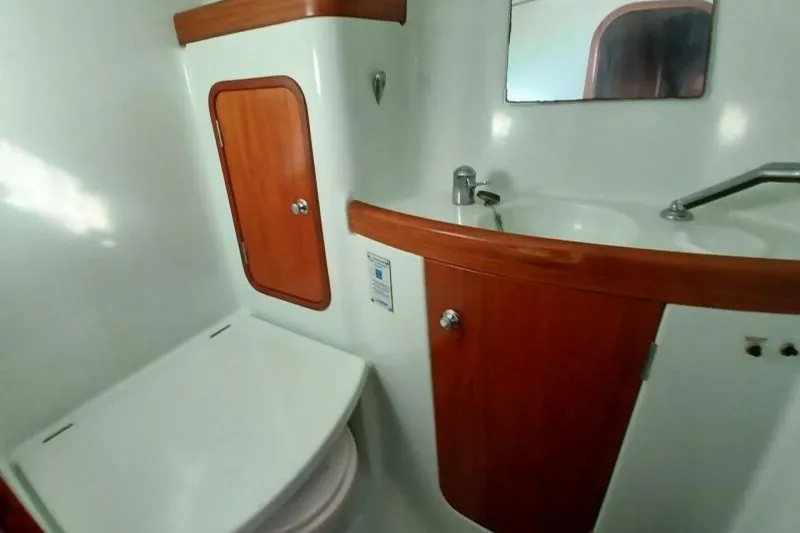 Slide: The Image of Bathroom interior of 1994 Beneteau Oceanis 44 CC yacht with wooden cabinetry and sink. - 66