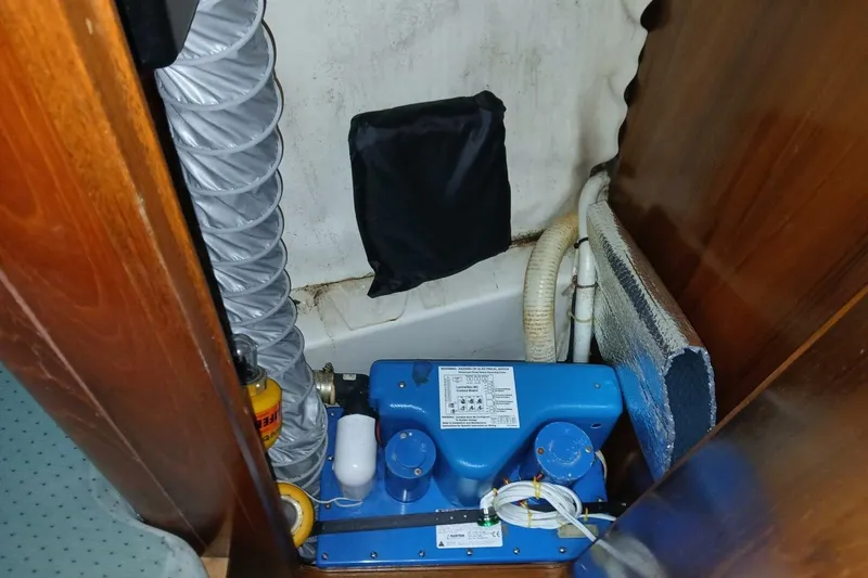 Slide: The Image of Engine compartment of a 1994 Beneteau Oceanis 44 CC sailboat, featuring mechanical components. - 73