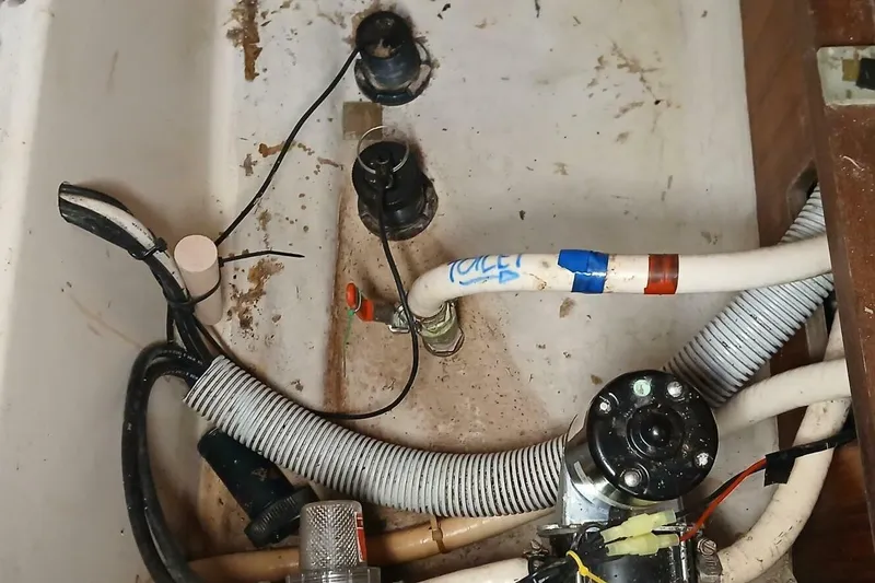 Slide: The Image of Bilge area of 1994 Beneteau Oceanis 44 CC with plumbing and wiring components. - 74