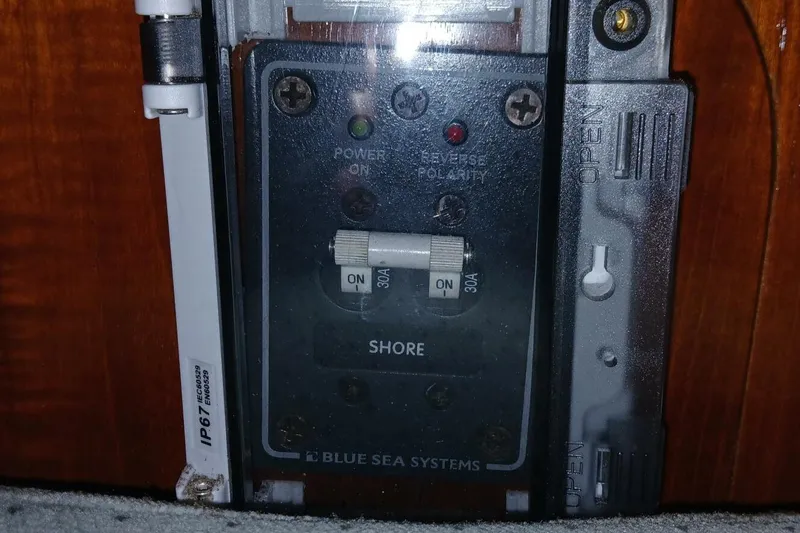 Slide: The Image of Electrical panel on a 1994 Beneteau Oceanis 44 CC sailboat, featuring Blue Sea Systems components. - 77