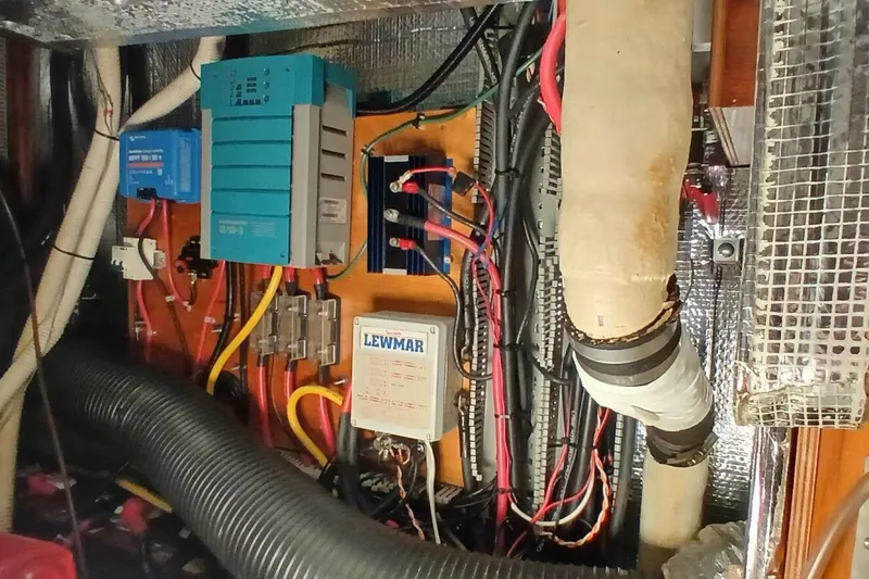 Slide: The Image of Electrical system inside a 1994 Beneteau Oceanis 44 CC sailboat, featuring wiring and components. - 79