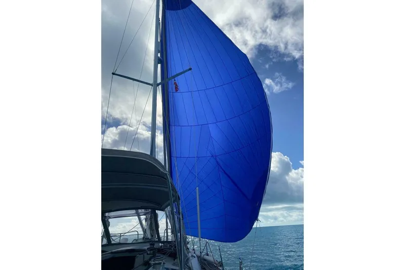 Slide: The Image of Sailing yacht Beneteau Oceanis 44 CC 1994 with blue spinnaker against cloudy sky. - 8
