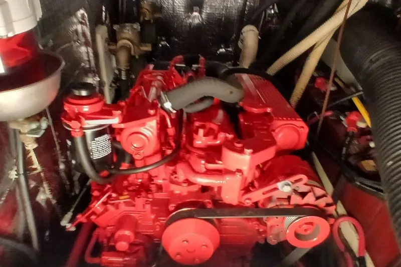 Slide: The Image of Engine room of a 1994 Beneteau Oceanis 44 CC sailboat, featuring a red marine engine. - 81