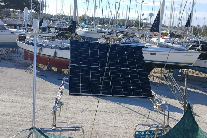 Slide: The Image of Beneteau Oceanis 44 CC sailboat with solar panels, docked in a marina, 1994 model. - 83