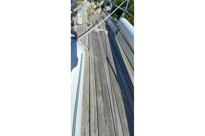Slide: The Image of Deck of 1994 Beneteau Oceanis 44 CC sailboat with wooden planks and railing. - 87