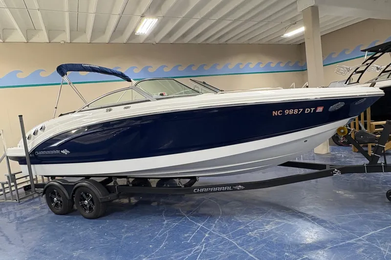 The Image of 2012 Chaparral 246 SSi boat on trailer in indoor showroom setting. - 0
