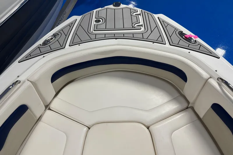 Slide: The Image of Bow seating area of 2012 Chaparral 246 SSi boat with cushioned seats and deck. - 11