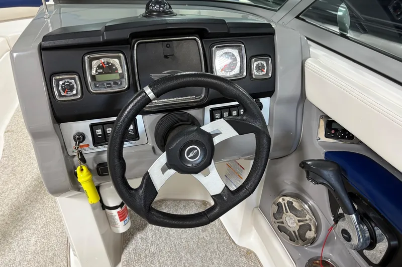 Slide: The Image of 2012 Chaparral 246 SSi boat dashboard with steering wheel and control panel. - 12