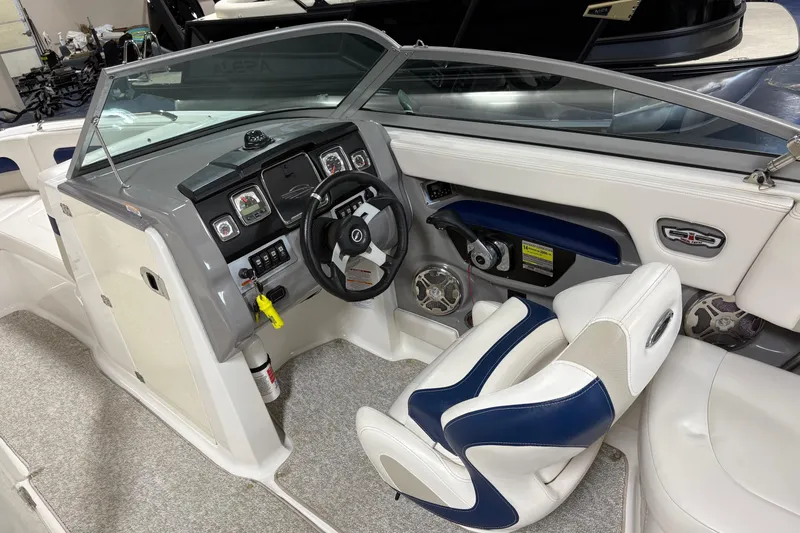 Slide: The Image of 2012 Chaparral 246 SSi boat interior with steering wheel and dashboard controls. - 13
