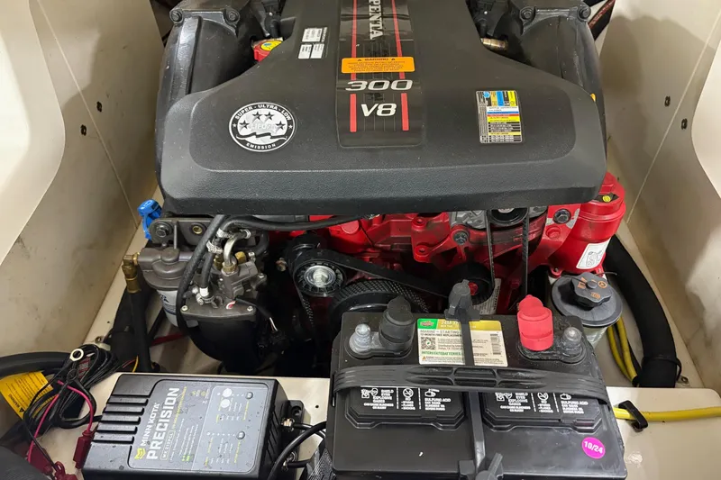 Slide: The Image of 2012 Chaparral 246 SSi engine compartment with V8 engine and battery setup. - 16