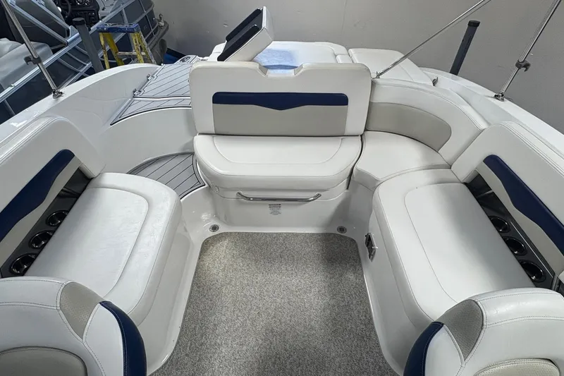 Slide: The Image of 2012 Chaparral 246 SSi boat interior with white and blue seating arrangement. - 5