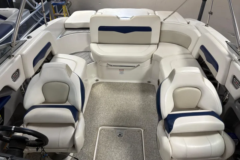 Slide: The Image of 2012 Chaparral 246 SSi boat interior with white and blue seating arrangement. - 6