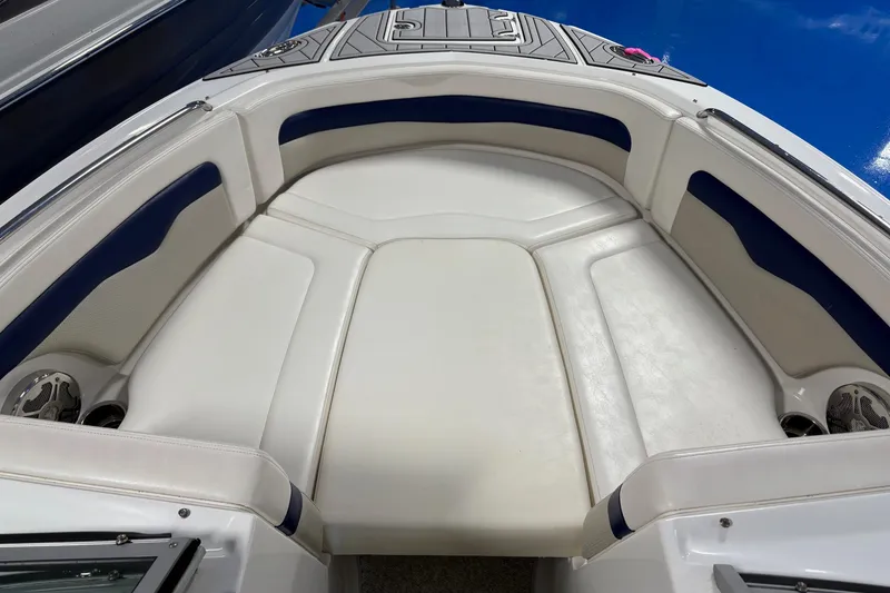 Slide: The Image of 2012 Chaparral 246 SSi boat interior with white and blue cushioned seating. - 9