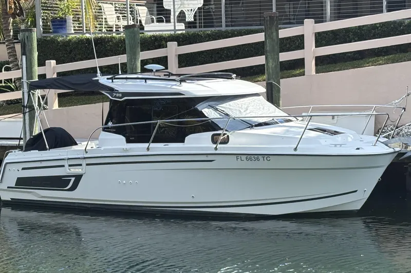 The Image of 2022 Jeanneau NC 795 Series 2 boat docked in a marina. - 0