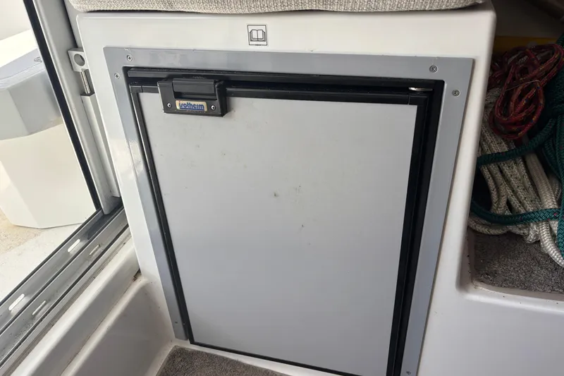 Slide: The Image of Interior view of 2022 Jeanneau NC 795 Series 2 boat kitchen area with sink and stove. - 10