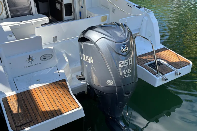 Slide: The Image of Fridge on 2022 Jeanneau NC 795 Series 2 boat, with ropes stored nearby. - 11