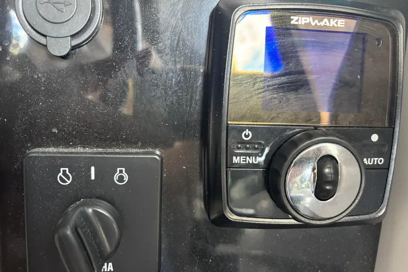 Slide: The Image of 2022 Jeanneau NC 795 Series 2 boat with covered outboard motor and wooden deck. - 14