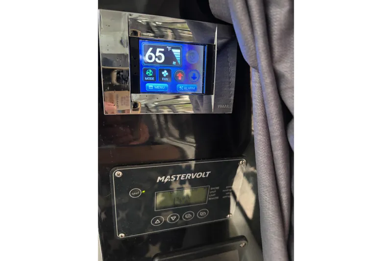 Slide: The Image of 2022 Jeanneau NC 795 Series 2 helm with steering wheel and navigation controls. - 15