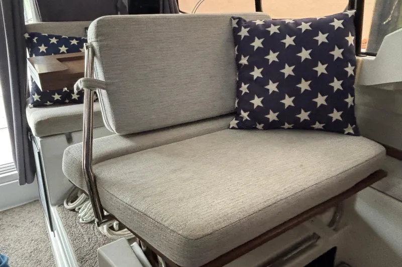 Slide: The Image of Interior seating of 2022 Jeanneau NC 795 Series 2 with star-patterned cushion. - 5