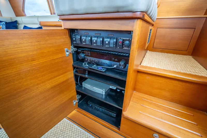 Slide: The Image of 2018 Palm Beach Motor Yachts PB50 interior control panel with wooden cabinetry. - 18