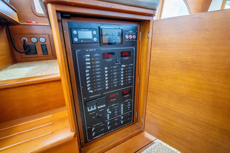 Slide: The Image of Electrical panel inside 2018 Palm Beach Motor Yachts PB50, showcasing control switches and meters. - 19