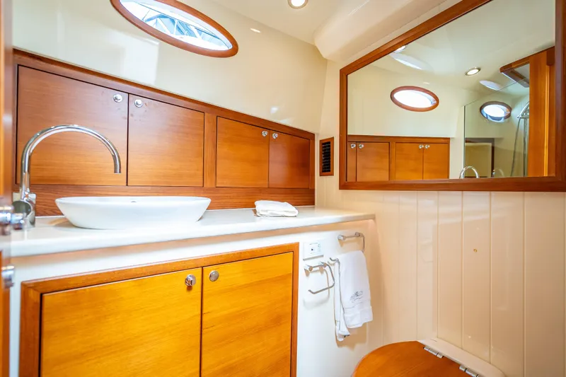 Slide: The Image of Luxurious 2018 Palm Beach Motor Yachts PB50 bathroom with wooden cabinetry and modern fixtures. - 24