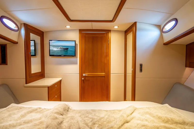 Slide: The Image of Luxurious 2018 Palm Beach Motor Yachts PB50 cabin interior with wood accents and modern amenities. - 27