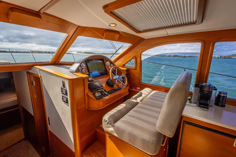 Slide: The Image of 2018 Palm Beach Motor Yachts PB50 helm with wooden interior and ocean view. - 3