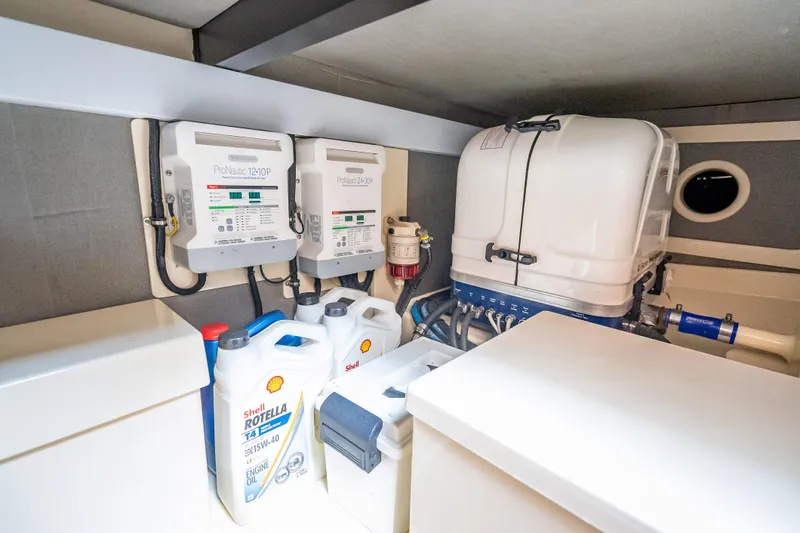 Slide: The Image of Engine room of 2018 Palm Beach Motor Yachts PB50 with equipment and oil containers. - 31