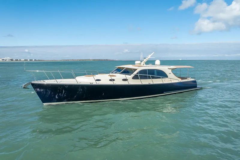 Slide: The Image of 2018 Palm Beach Motor Yachts PB50 cruising on open water under blue skies. - 35