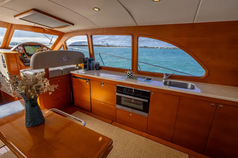 Slide: The Image of Luxurious interior of 2018 Palm Beach Motor Yachts PB50 with elegant wood finish and ocean view. - 14