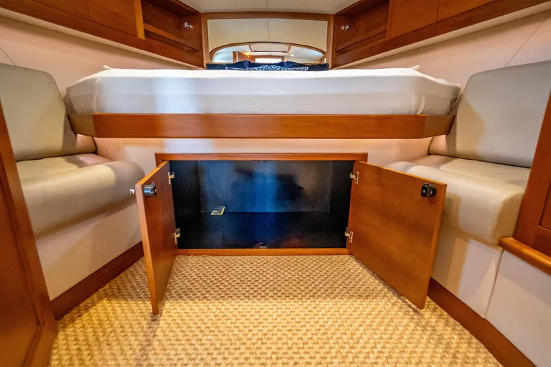 Slide: The Image of 2018 Palm Beach Motor Yachts PB50 cabin with open storage under bed. - 26