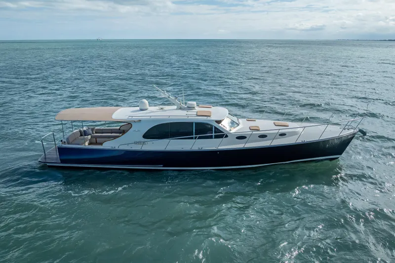 Slide: The Image of 2018 Palm Beach Motor Yachts PB50 cruising on open water under a cloudy sky. - 37