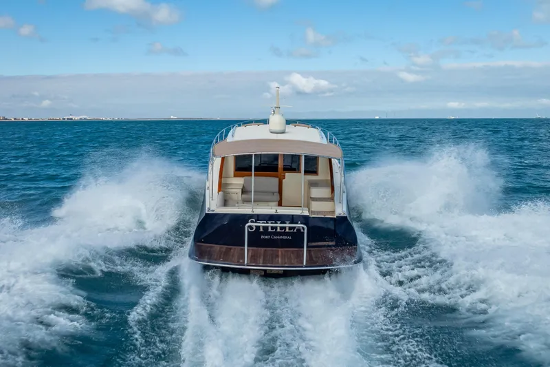 Slide: The Image of 2018 Palm Beach Motor Yachts PB50 cruising on open water, rear view. - 39