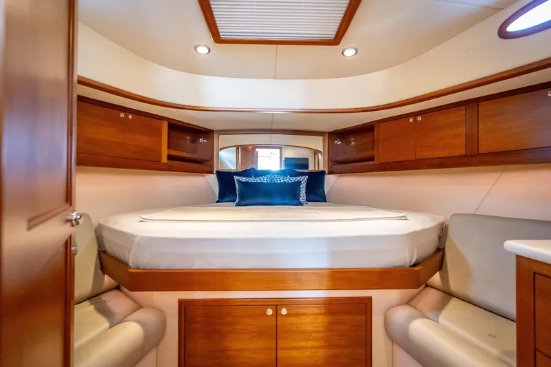 Slide: The Image of Luxurious 2018 Palm Beach Motor Yachts PB50 cabin with elegant wood finishes and cozy bedding. - 4