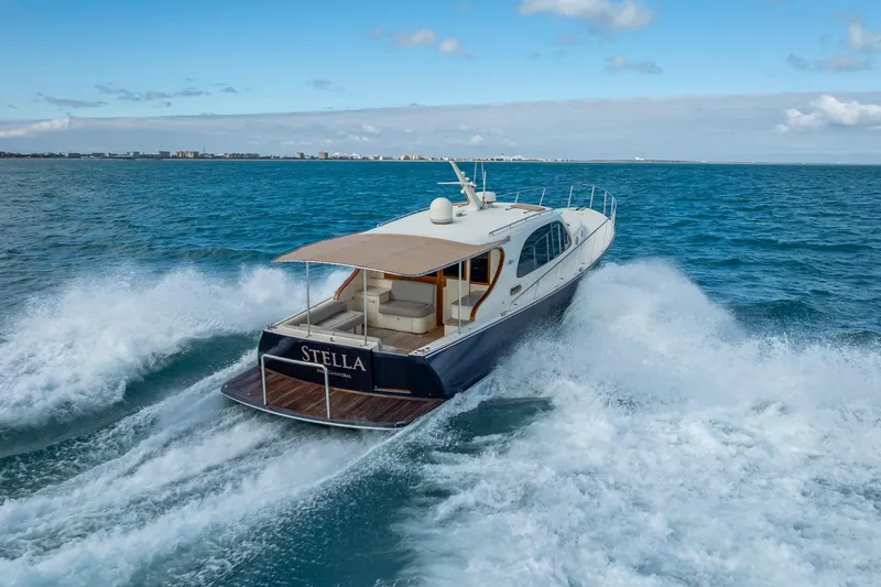 Slide: The Image of 2018 Palm Beach Motor Yachts PB50 cruising on open water, rear view. - 42