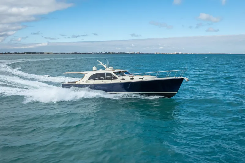 Slide: The Image of 2018 Palm Beach Motor Yachts PB50 cruising on open water under a clear sky. - 5