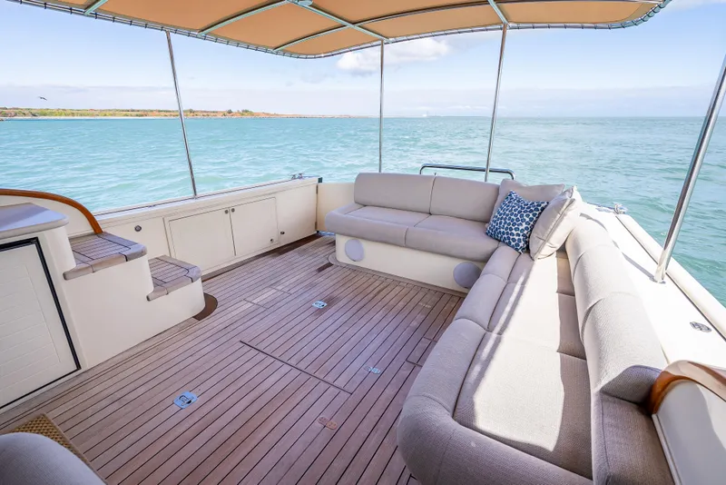 Slide: The Image of 2018 Palm Beach Motor Yachts PB50 interior with elegant seating and ocean view. - 9