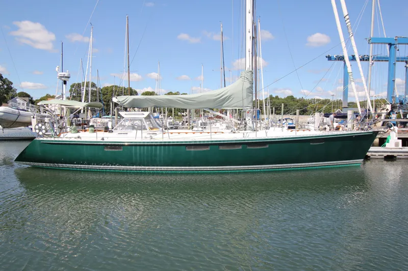 The Image of Sailboat docked in marina, Able Apogee 50, 1998 model, green hull, clear sky. - 1